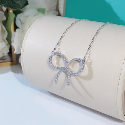 CLAW SET RHODIUM PLATED BOW NECKLACE